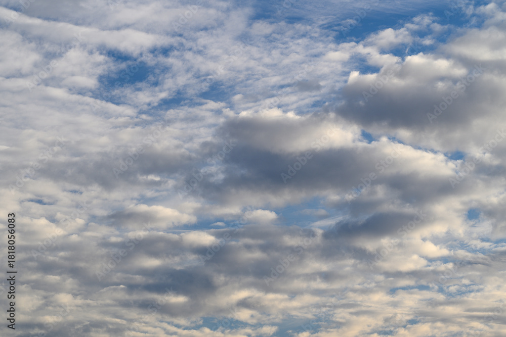 Fototapeta premium A Dramatic Cloudscape with a Beautiful Blue Sky and Soft Shadows, Perfect for Inspiration