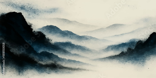 Dramatic summer landscape: mountains in the fog under a blue cloudscape with the sunlight breaking through