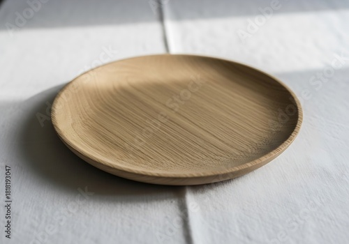 Rustic charm showcases a wooden plate on white fabric backdrop under light