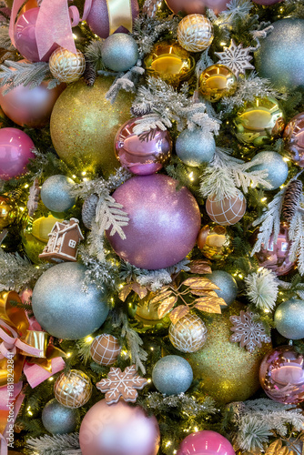 Close up shot of colorful ornaments decoration elements on Christmas tree .