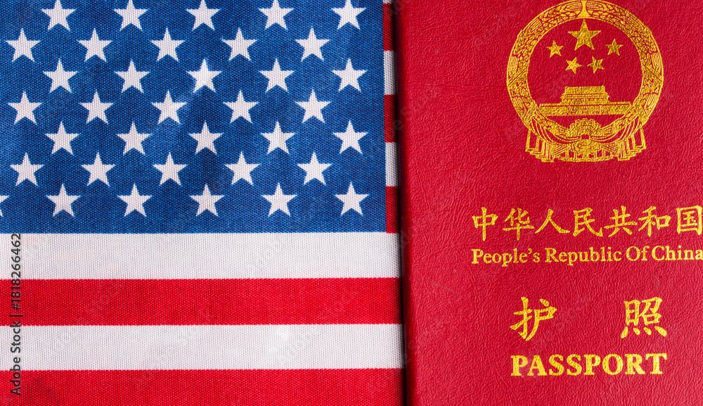 Fototapeta premium A Chinese passport against the backdrop of the US flag