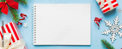 Christmas blank greeting card mock-up scene. Creative layout made of Christmas tree branches and paper card note. Flat lay. Nature New Year concept