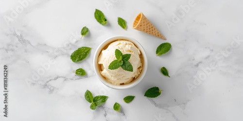 Bowl of ice cream with cones and mint leaves on a white table, ideal for dessert presentation or menu background