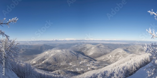 Fototapeta Naklejka Na Ścianę i Meble -  Winter mountain scene with snow-capped peaks viewed from a high vantage point in the Tatras, emphasizing seasonal landscape preservation