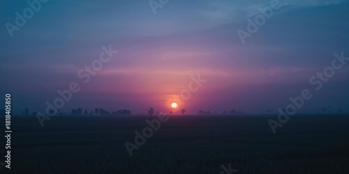 Sunset over rural fields wi...