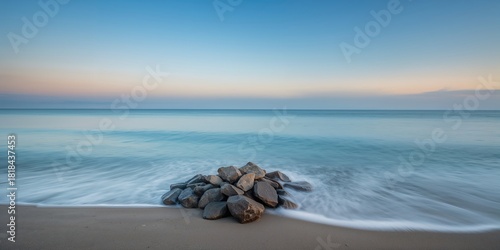 Fototapeta Naklejka Na Ścianę i Meble -  Coastal stones in the haze, serving as a natural background for layout design