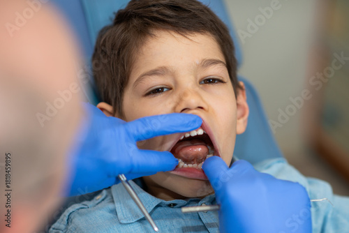 A dentist examines a boys teeth to prevent cavities and promote oral health. Regular checkups maintain strong teeth and confidence, fostering lifelong healthy habits.