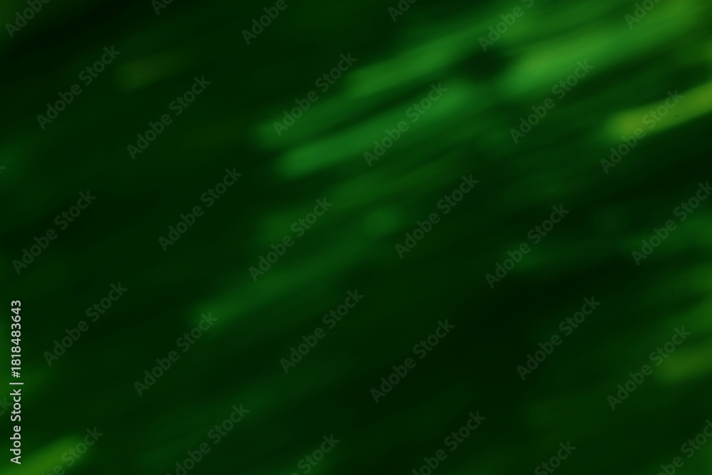 Obraz premium Abstract dappled green light streaks against a dark emerald background creating a moody