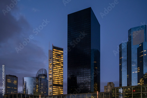Architecture skyscrapers skyline night corporate finance urban modern within la defense paris france reinforcing a distinctive business oriented scene with clean vertical forms