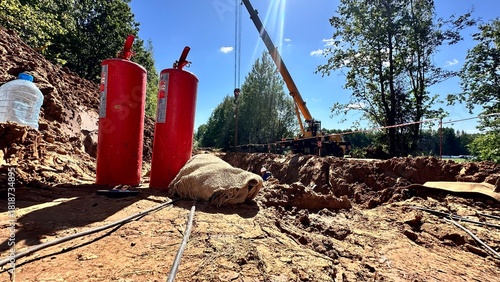 The photo shows hazardous gas work being carried out to replace a gas pipe; in the foreground there is a fire extinguisher to fight the fire.