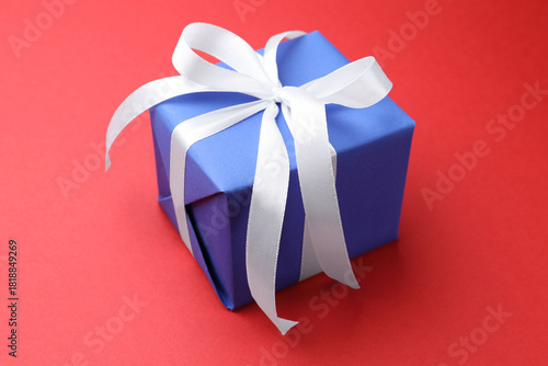 Konstfotografi Beautiful gift box on red background, closeup