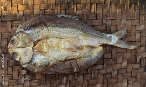 Salted milkfish (Ikan Bandeng Asin) on traditional woven bamboo tray