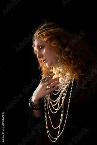 Beautiful bohemian and Pre-Raphaelite model with long red hair, adorned with pearl necklaces and a pearl headdress