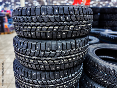 New car studded tires in the store. Sale of car winter tires. Rubber for the winter season.