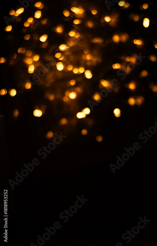 Blurred Christmas lights background with golden holiday bokeh. Abstract vertical banner for New Year 2026