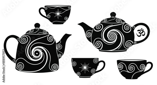 Elegant black teapots and cups adorned with swirling patterns and spiritual symbols