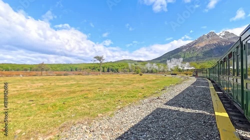 A historical steam locomotive winds through Tierra del Fuego National Park in Ushuaia, Argentina, offering a glimpse into the past as it follows tracks built by prisoners.