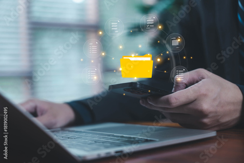 Digital file transfer between smartphone and laptop, representing data management, cloud document syncing, online storage, mobile workflow, and secure digital information sharing.