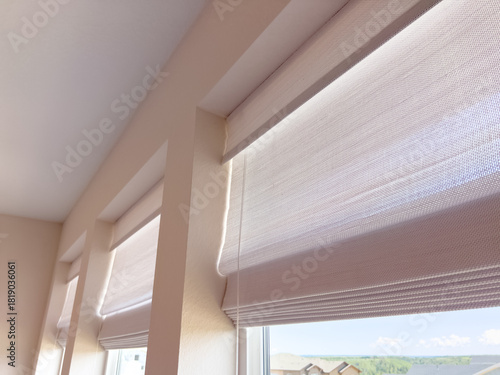 Sunlit Room With Roman Shades And Triple Window