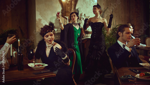 Canvas Print Elegant women raising glasses in joyful vintage-themed celebration