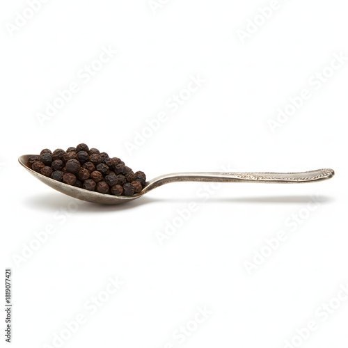 Old Metal Tablespoon Filled with Black Peppercorns Isolated on White