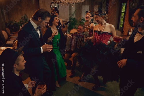 Canvas Print Retro group laughing and dancing with accordion player during lively vintage party night