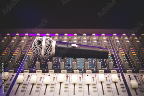 dynamic microphone on audio mixing console. singing, recording concept