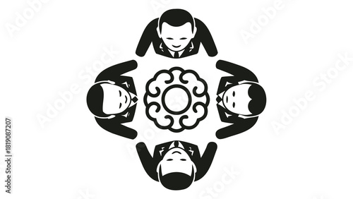 Diverse group of four professionals collaborating closely in a huddle brainstorming ideas and discussing a project with focused expressions and engaged body language