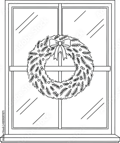 Christmas wreath hanging on a window in black and white