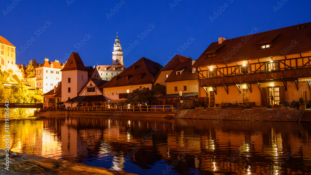 Naklejka premium Cesky Krumlov in the evening from a boat on the Vltava River