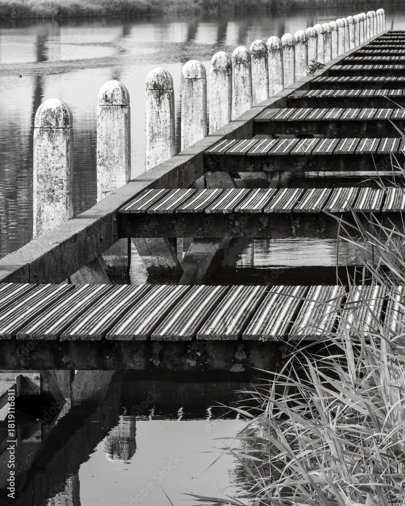 Fototapeta premium Landing stage on a canal, greyscale shot