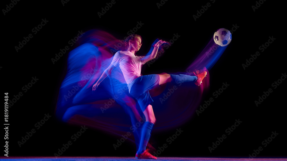 Fototapeta premium Female soccer player striking ball in motion blur with neon trail. Concept of sport campaign visuals, motion design, fitness advertising, and coaching materials.
