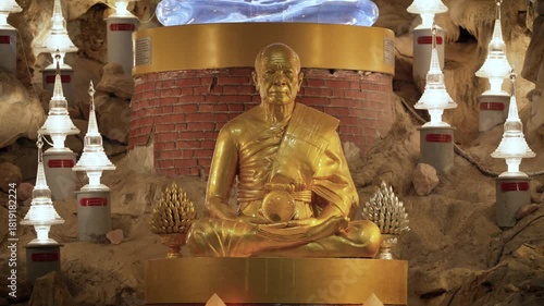 Khao Wong Cave, Khao Yai, Thailand - November 23, 2025: Statue of Luang Phor Sodh Candasaro, the famous Thai monk master, inside a cave temple. Golden monk sculpture for worship.