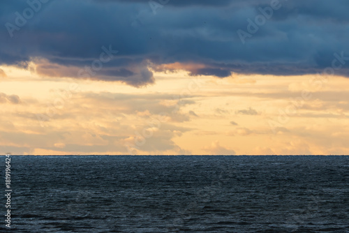 Tableau sur toile Dramatic golden sunset sky with dark heavy clouds over the choppy Baltic Sea hor