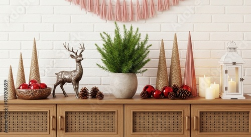 A stylish Christmas composition with a reindeer figurine, miniature tree, red baubles, and glowing candles arranged on a modern wooden sideboard with rattan details