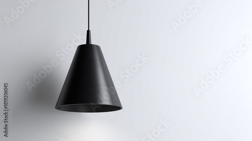 A modern black pendant lamp against a neutral backdrop, minimalist decor. The lamp's conical shade casts a gentle light