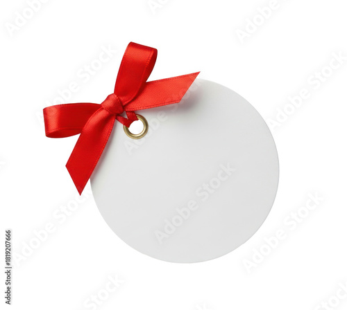 A white round tag with a red ribbon tied around it.