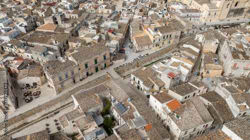 Fototapeta Naklejka Na Ścianę i Meble -  Aerial view of the historic center of Scicli, in the province of Ragusa, Sicily, Italy. There is a small road that runs through the town.