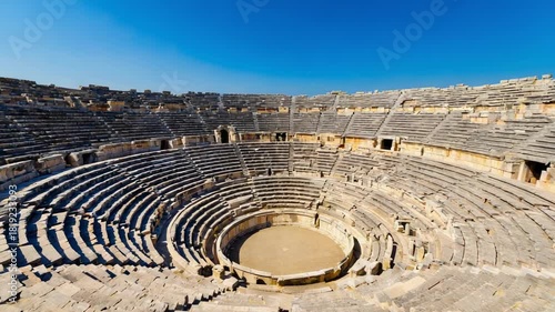 Ancient Stone Amphitheater Under a Clear Blue Sky ruins architecture