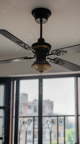 Elegant ceiling fan with ornate details and vintage style lighting for a modern home interior design project