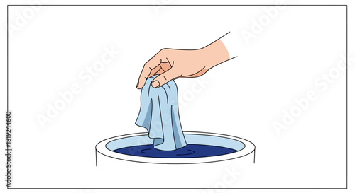 Hand dipping cloth into liquid in a bowl for cleaning or dyeing.