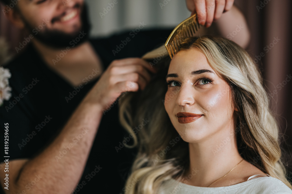 Fototapeta premium A client in a hair studio receives a professional styling session, with a stylist brushing her blonde locks. The scene conveys beauty, care, and confidence in a modern salon setting.