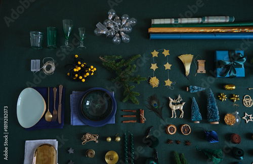 Christmas festive preparation concept flat lay on the green linen fabric. Xmas objects for table and tree decoration