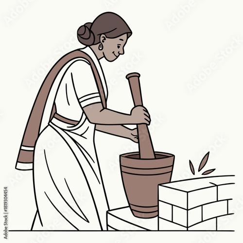 Traditional indian woman in sari grinding spices with a mortar and pestle in a village setting