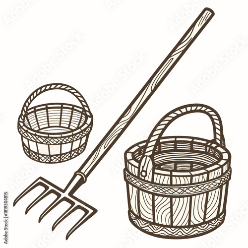 Rustic wooden pitchfork and two woven baskets for gardening and harvesting produce