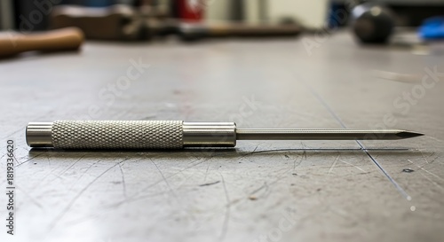 Precision Metal Scriber Tool Laying on Industrial Surface Close-Up Shot