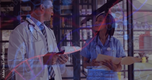 Reviewing documents doctor in coat and nurse in scrubs at clinic corridor, stethoscopes DNA overlay
