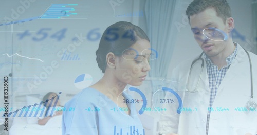 Reviewing labcoat doctor and light-blue scrub nurse studying overlays in ward with stethoscope