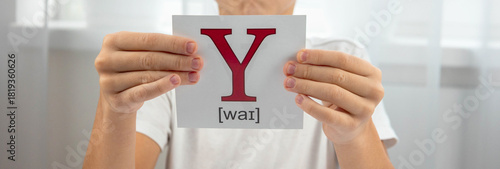 Quadro su tela Boy presenting a flashcard with the letter Y and its phonetic transcription for