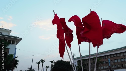 Moroccan RedFlags Waving in the Wind against Clear Sky